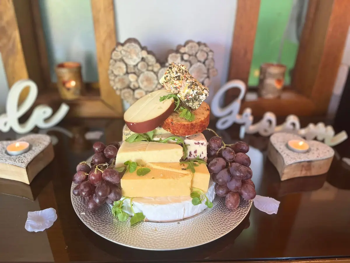 Afternoon tea spread by Justine Wood at Millbrook Estate, Devon — sandwiches, home-baked treats and cheese and meat platters
