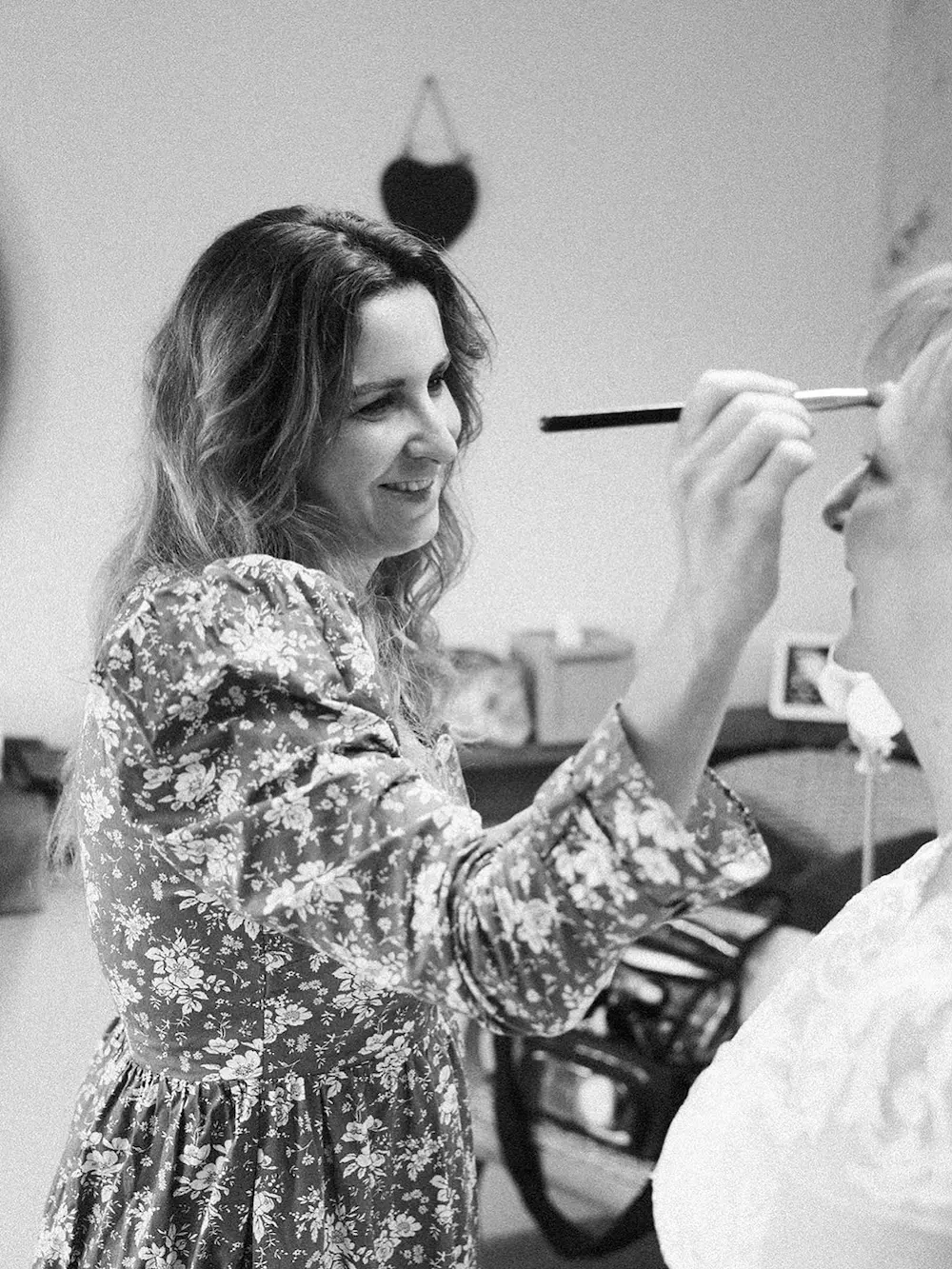 Mercedes Hayward applying bridal makeup to a bride at an elopement wedding in Devon